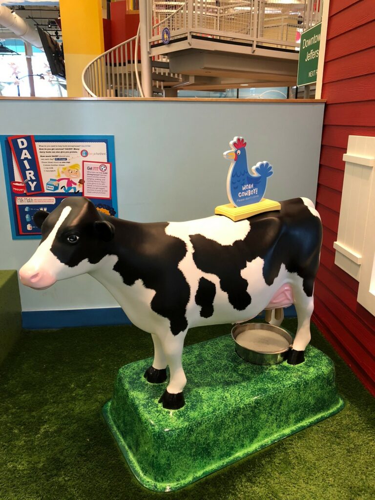Guests can try their hand at milking a pretend cow.